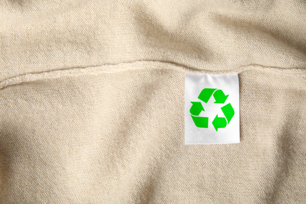 Embracing Circularity in Retail: A Path to Sustainability. Clothing label with recycling symbol